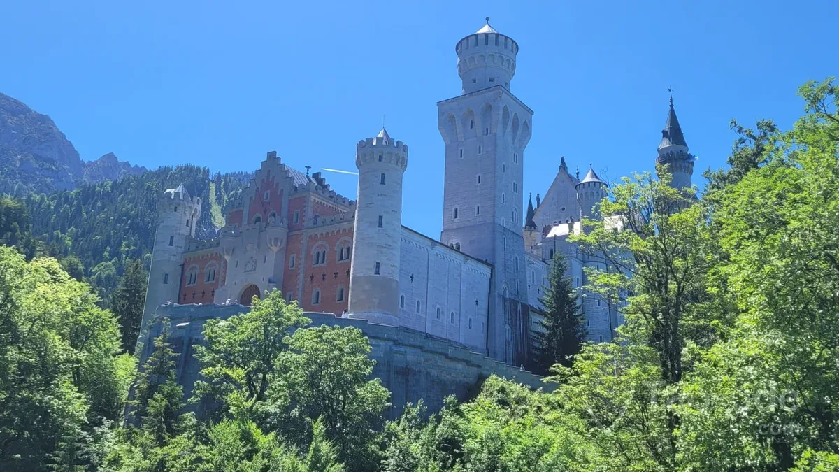 Neuschwanstein Castle surrounded by Bavarian forests and mountains during a private guided Germany tour