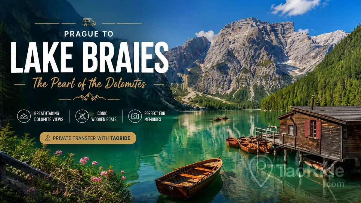 Lake Braies (Lago di Braies) in the Italian Dolomites with emerald-green water, traditional wooden boats, and dramatic mountain peaks under a clear summer sky.