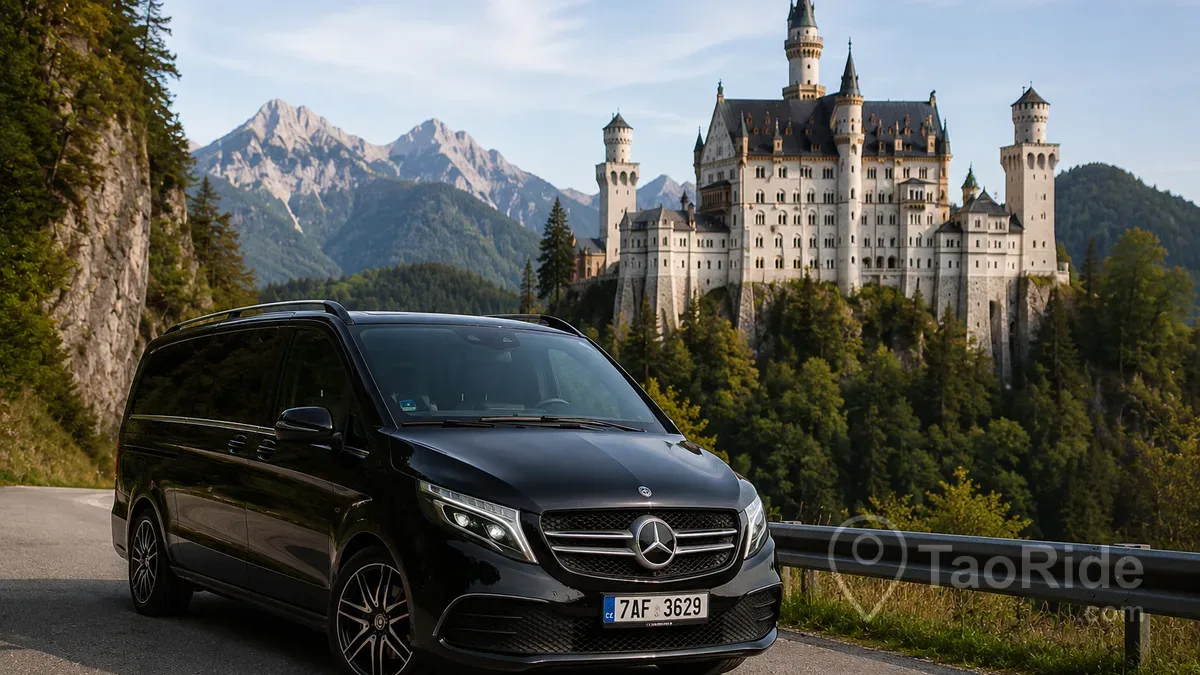 Mercedes-Benz V-Class private transfer parked near Neuschwanstein Castle in Bavaria, Germany, offering comfortable transportation from Prague with breathtaking Alpine scenery in the background.