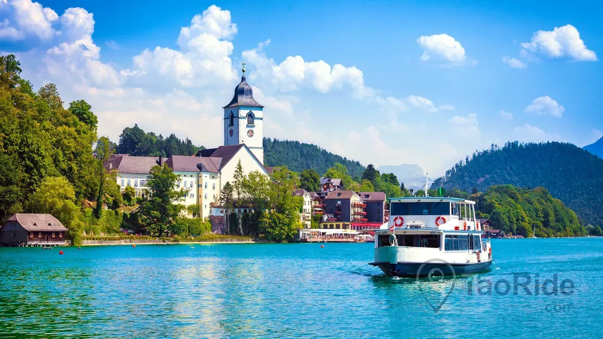 Traditional passenger boat cruising across Lake Wolfgang in Salzkammergut Austria