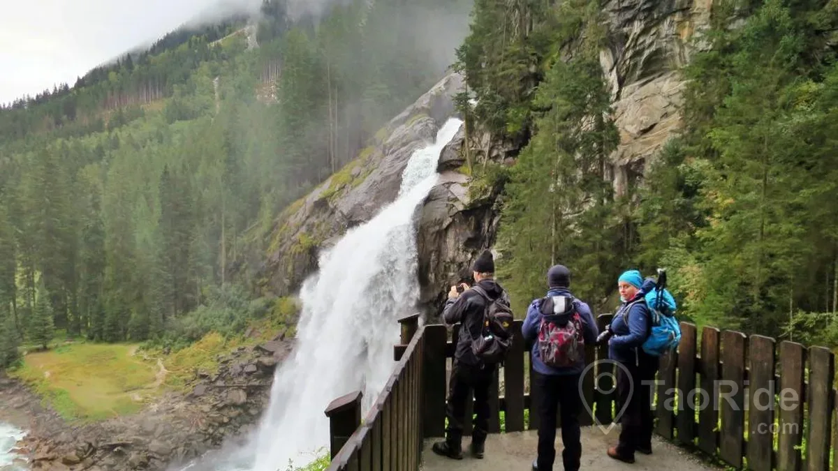 Panoramic view of Krimml Waterfalls in Austria featuring powerful cascading waterfalls, scenic hiking trails, lush Alpine forests, and the breathtaking landscapes of Hohe Tauern National Park.