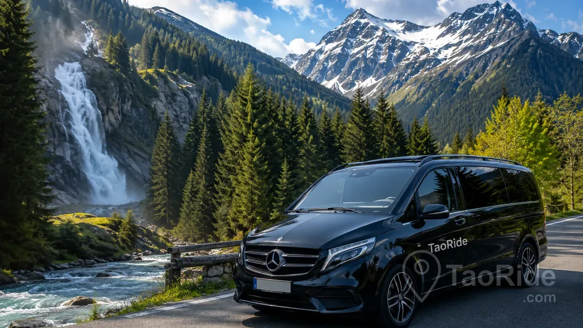 Premium Mercedes private transfer near Krimml Waterfalls in Austria surrounded by Alpine mountains, forest roads, crystal-clear rivers, and the spectacular landscapes of Hohe Tauern National Park.