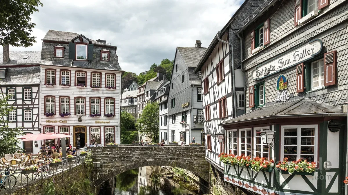 Historic stone bridge crossing the Rur River in Monschau Old Town, Germany.