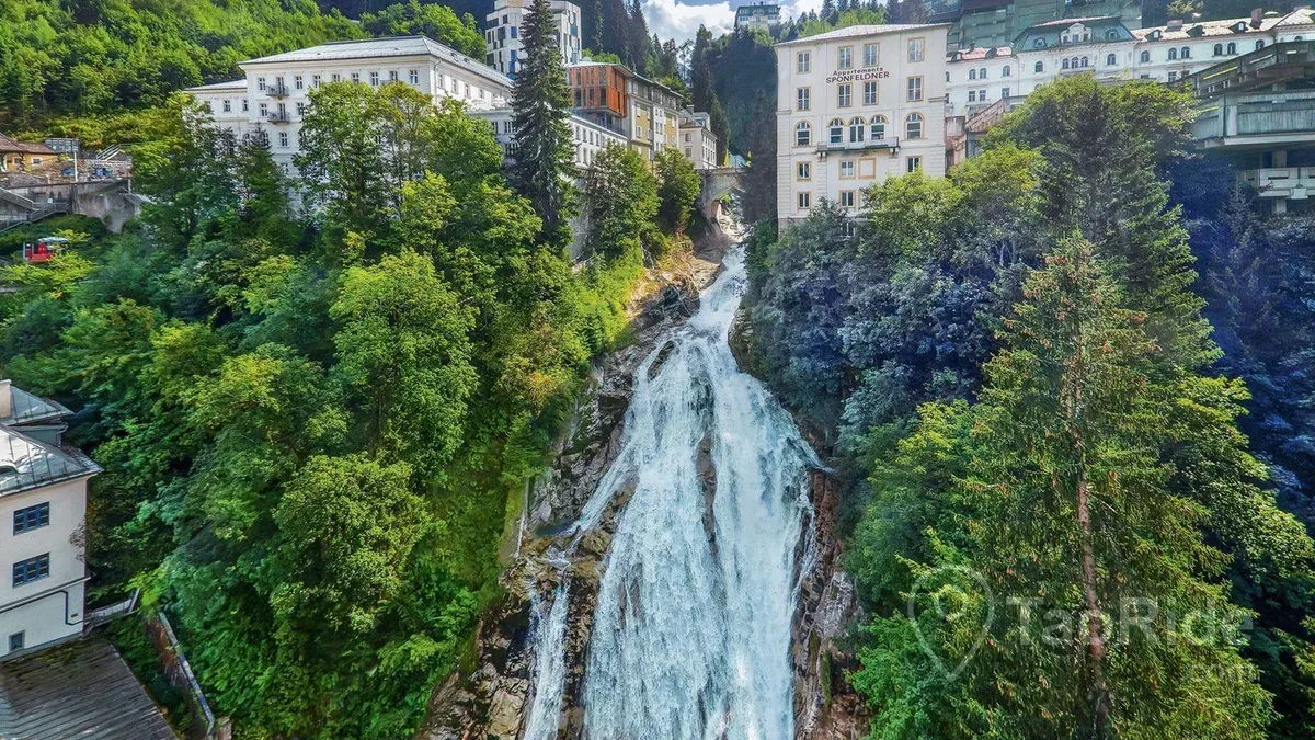The famous Gastein Waterfall flowing through the historic center of Bad Gastein, Austria